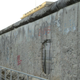 Remains of the Berlin Wall. Berlin’s flag is flying over the parliament building of the city-state